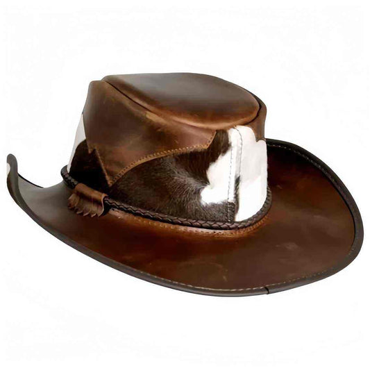 Men's brown distressed leather cowboy hat with genuine hair-on black and white cowhide fur hatband panel and braided leather cord — side profile view on white background