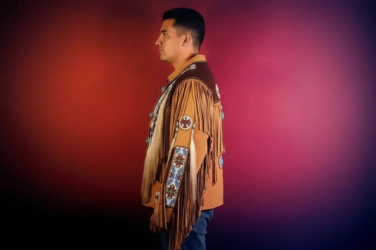 Side view of a man wearing a handcrafted tan suede fringe shirt with intricate beadwork.