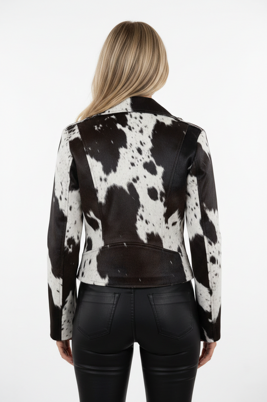 Person wearing a black and white cowhide leather jacket on a white background