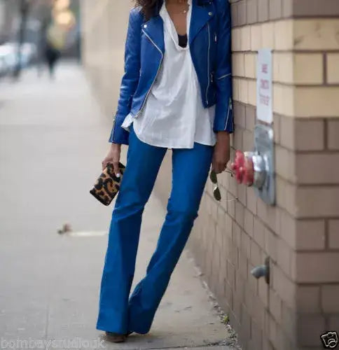 Woman wearing a Zhim Leather Creations blue leather jacket and matching blue trousers.