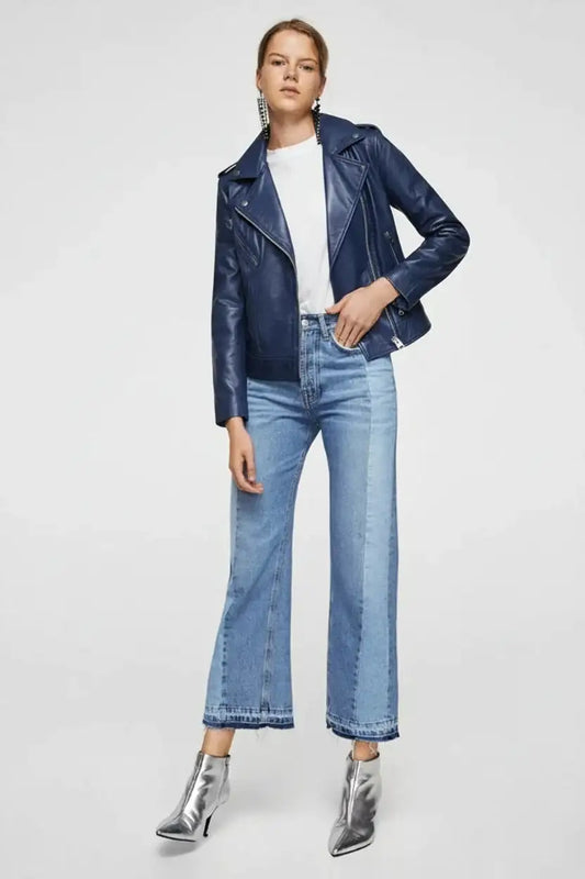 Woman wearing a Zhim Leather Creations navy blue leather biker jacket and blue jeans.
