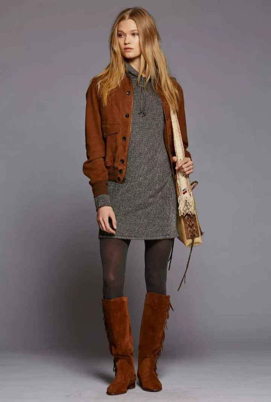 Woman wearing Zhim Leather Creations brown suede cowboy jacket and fringe boots.