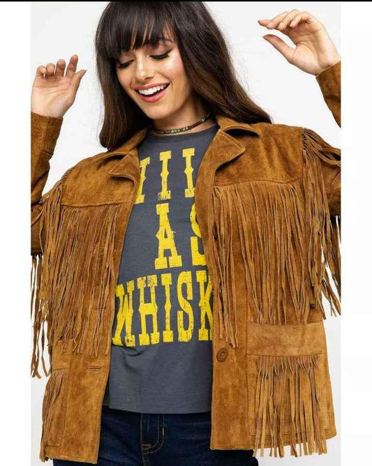 Woman wearing a tan suede fringe cowboy jacket by Zhim Leather Creations
