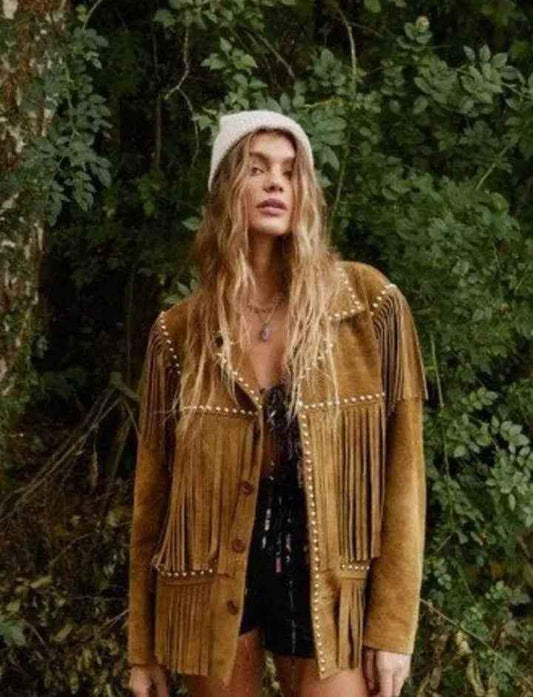 Woman wearing a Zhim Leather Creations brown suede fringe cowboy jacket in a forest setting.