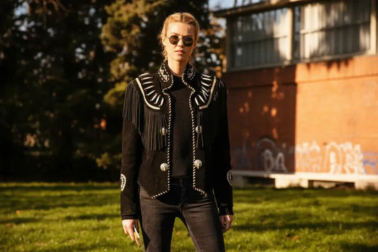 Woman wearing a Zhim Leather Creations black suede fringe jacket with western beadwork.