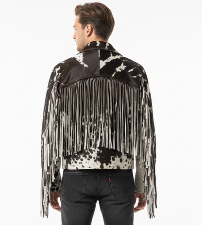 Man wearing a black and white ponihair cowhide leather jacket with fringes on a white background