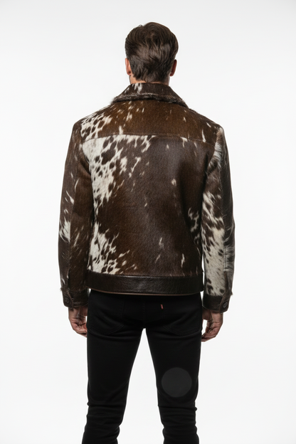Person wearing a brown and white cowhide leather jacket on a white background