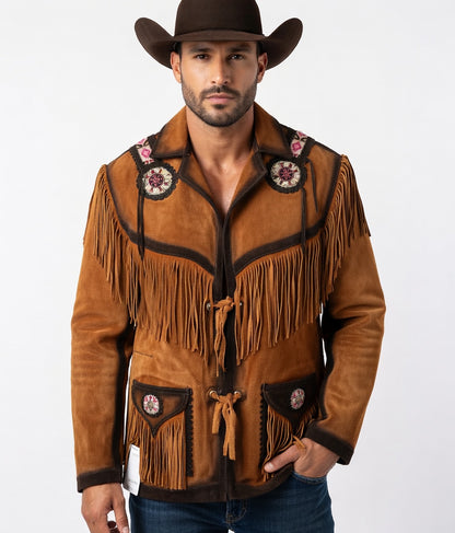 Man wearing a brown suede jacket with fringes and floral patterns, standing against a white background.