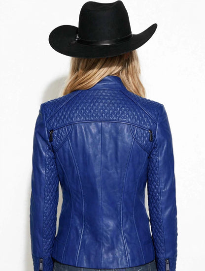 A woman shown from the back wearing a bright blue leather jacket with quilted shoulder panels and a black cowboy hat, against a plain white background.