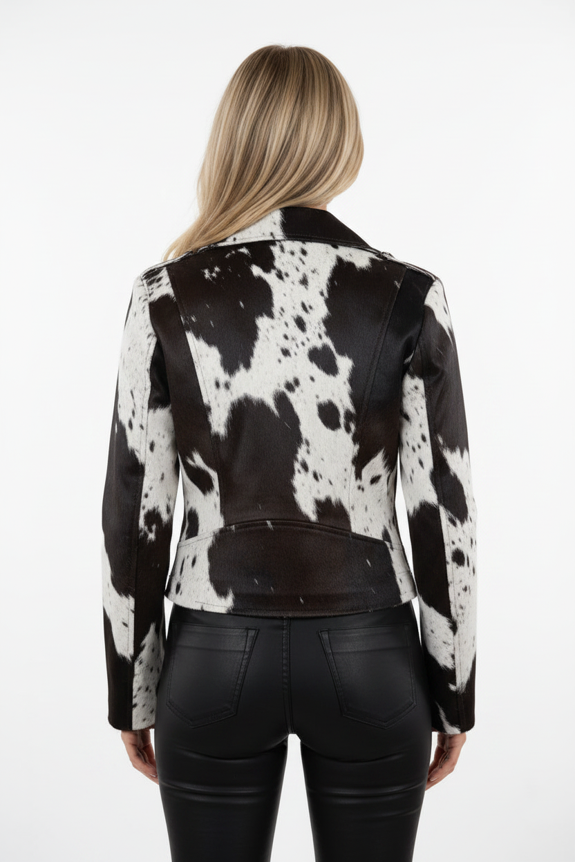 Person wearing a black and white cowhide leather jacket on a white background