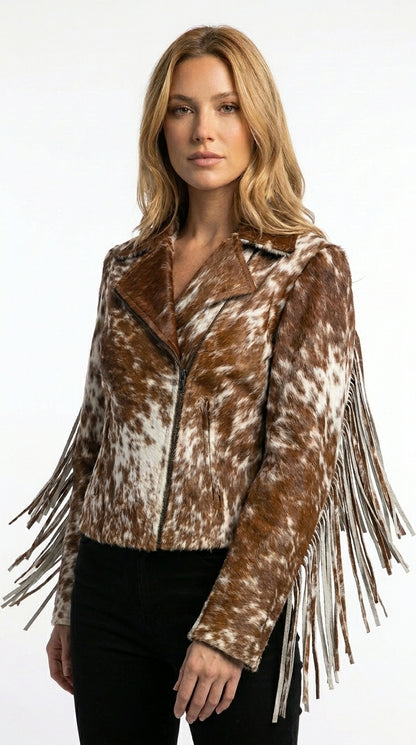 Woman wearing a brown and white patterned jacket with fringes on a white background
