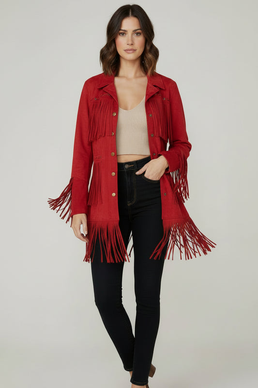 Woman wearing a red fringed jacket on a plain background
