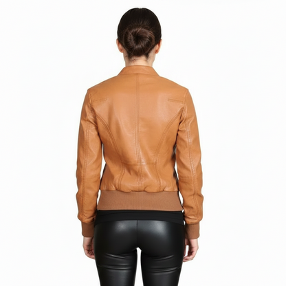 A woman wearing a brown real leather jacket back view with a standing collar, zipper details, and fringe accents on the sleeves.